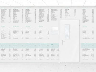 Hospital corridor with blank wall mockup and door, 3d render. Room sign mock up template on entry in ward. Medical hall interior sickroom. Clear closed door signage plate. Infirmary light hallway. wall has lists of health care prices listed on it that are not quite legible.